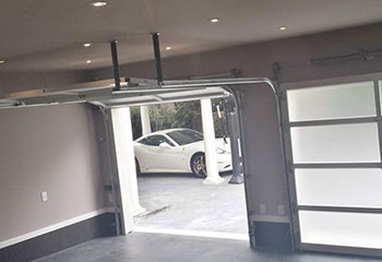 Completed double electric glass garage doors with aluminum frames in Coon Rapids garage
